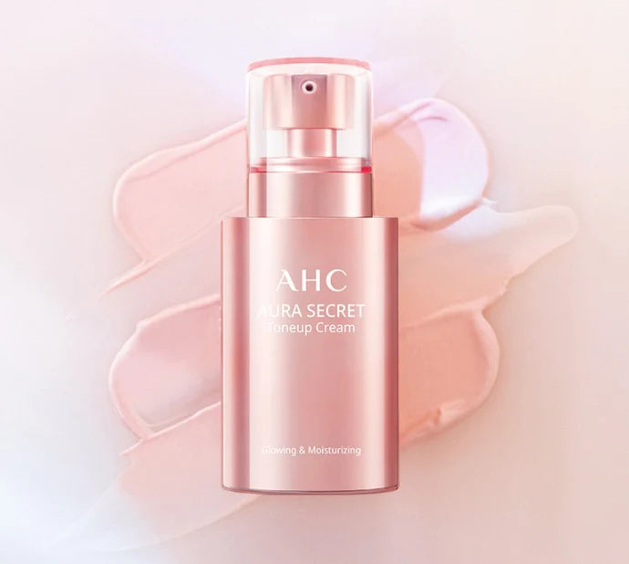 A pink bottle of AHC Aura Secret Tone Up Cream SPF30 PA++ by AHC is placed on a light pink background. The bottle features a pump dispenser and is labeled "Glowing & Moisturizing." You can purchase it at MyAllures.