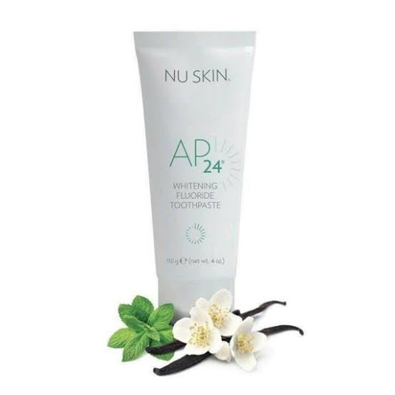 Image of NUSKIN AP 24 Whitening Fluoride Toothpaste packaging displaying benefits, usage instructions, and a smiling woman. Benefits include teeth whitening, removal of stains and plaque, and no harmful peroxides. Available for purchase at MyAllures.