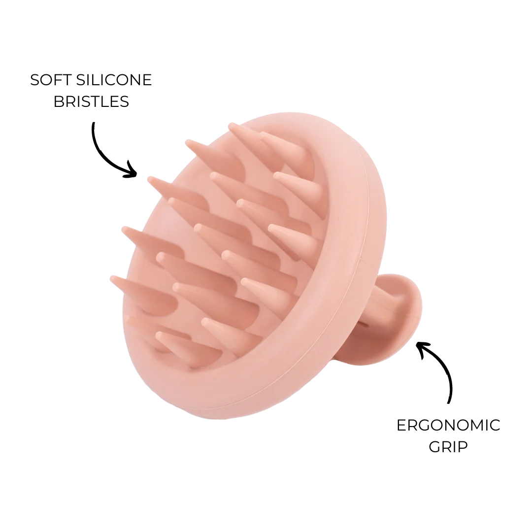 A hand holding the CHEEKYGLO SCALP SCRUBBER by CHEEKYGLO showcases its ergonomic handle, 100% BPA-free silicone teeth, and versatility for use on both dry and wet hair. Arrows point to these features with explanatory text. Purchase it at MyAllures for the ultimate hair care experience.