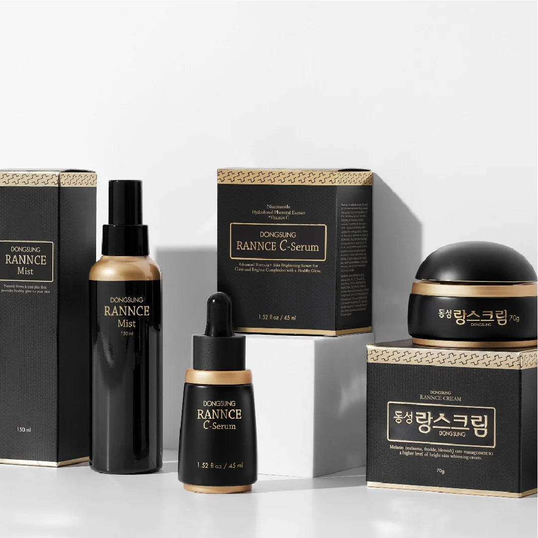 A collection of Dongsung Rannce skincare products, including a mist, C-serum, and cream, arranged on a surface with their boxes. Buy the DONGSUNG RANNCE SPECIAL SET at MyAllures for an exclusive touch of luxury and rejuvenation.