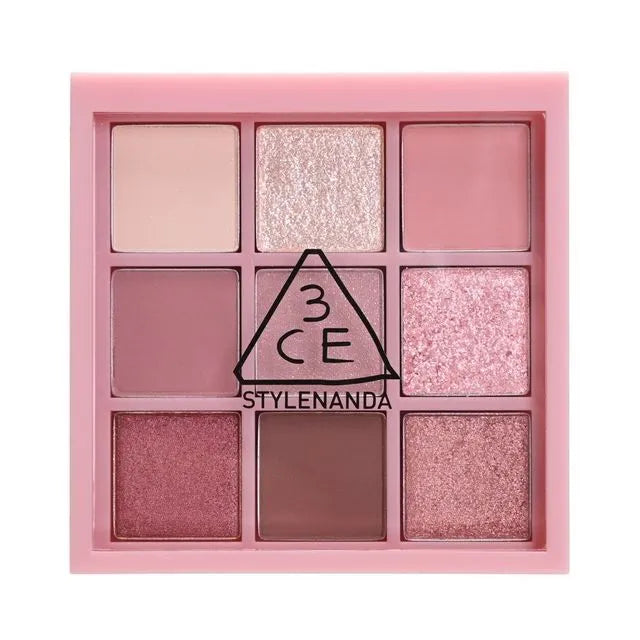 Nine-shade eyeshadow palette in pink and neutral tones, featuring a combination of matte and glitter finishes, labeled "3CE MULTI EYE COLOR PALETTE". Purchase at MYALLURES for an effortlessly chic look.