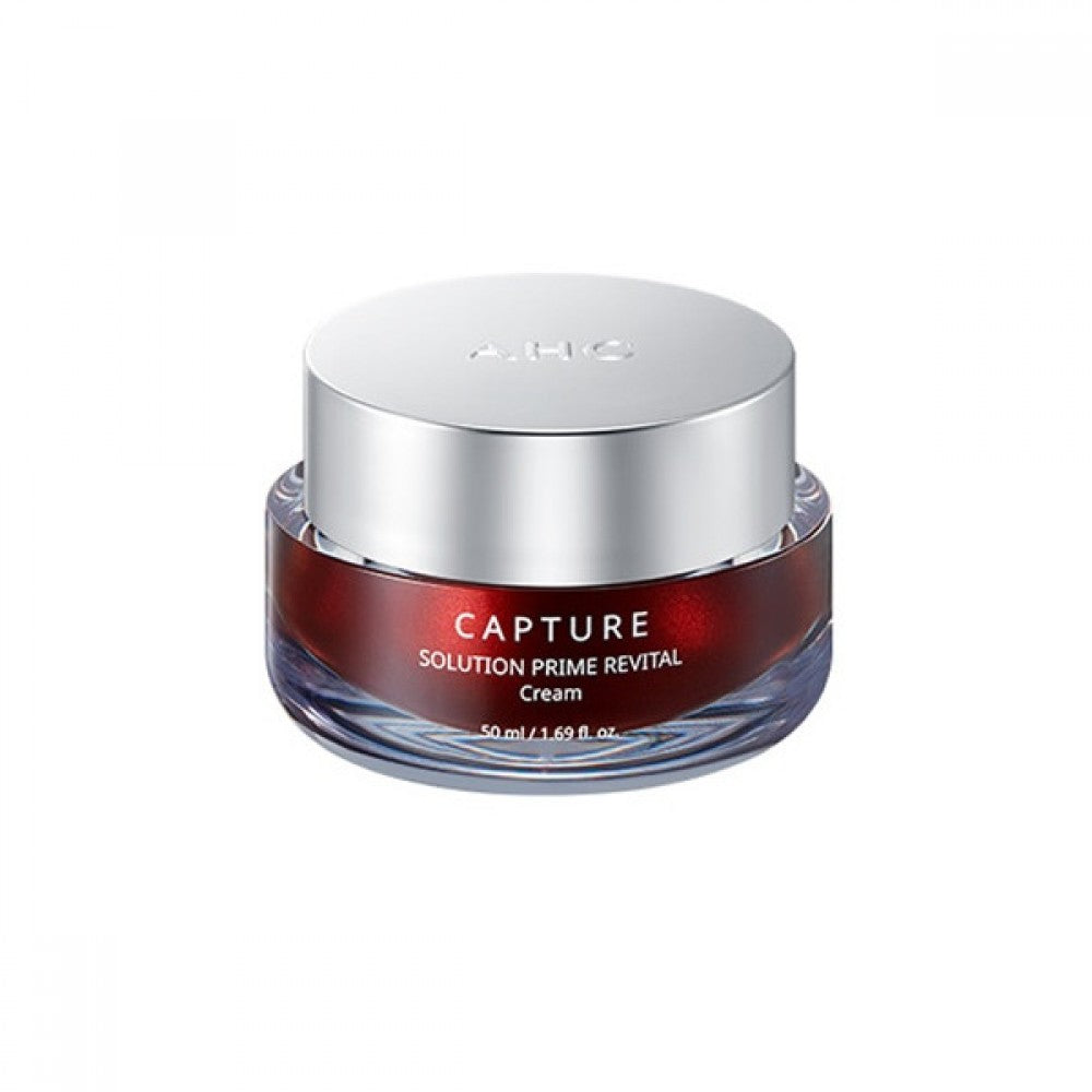 A jar of AHC Cature Solution Prime Revital Cream, 50 ml, with a metallic silver cap and a gradient red to clear body. Available for purchase at MyAllures.