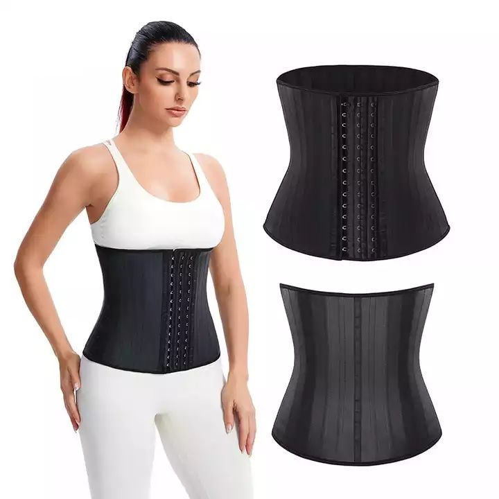 A person wearing a beige LATEX CORSET over a black outfit, highlighting the midsection. Buy at MyAllures.