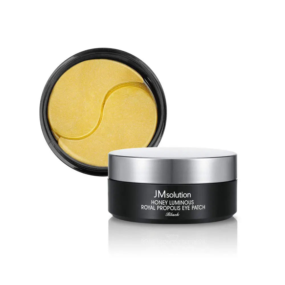 With the lid off, a container of JMsolution Moisture Eye Patch 60PCS reveals golden eye patches inside. Buy at MyAllures for a luxurious skincare experience.