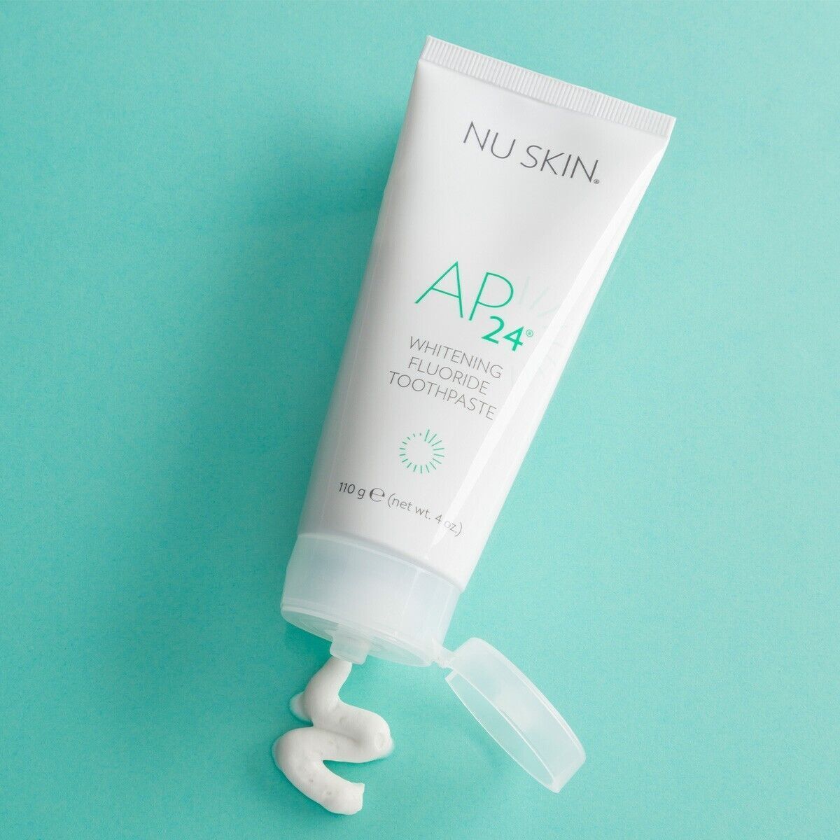 Image of NUSKIN AP 24 Whitening Fluoride Toothpaste packaging displaying benefits, usage instructions, and a smiling woman. Benefits include teeth whitening, removal of stains and plaque, and no harmful peroxides. Available for purchase at MyAllures.