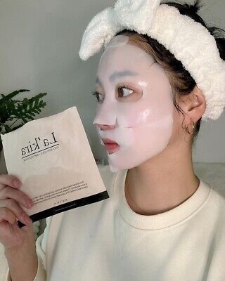 A person applying a LAKIRA Collagen Cica Ampoule Mask at home. The image captures the mask packet being held and the individual with the mask on their face from two different angles. For this rejuvenating experience, be sure to purchase it at MyAllures.